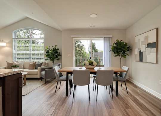 A dining room with a table set for four.