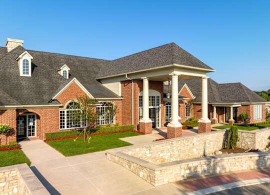 a large brick house with columns and a porch