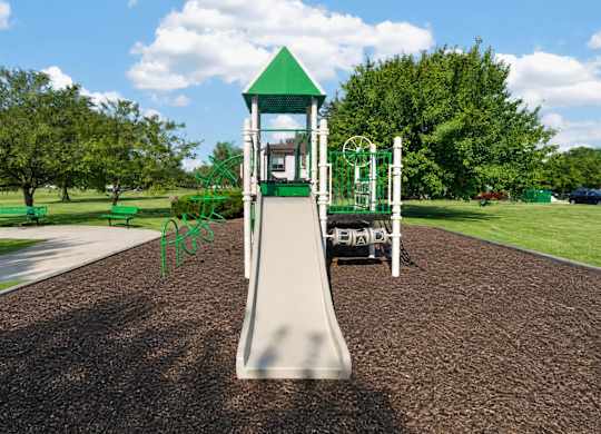 A playground with a green slide and a white tower.