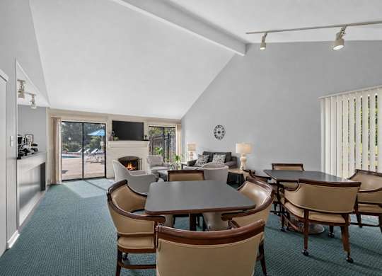 A dining room with a table and chairs.