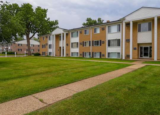 A long building with a lawn in front.