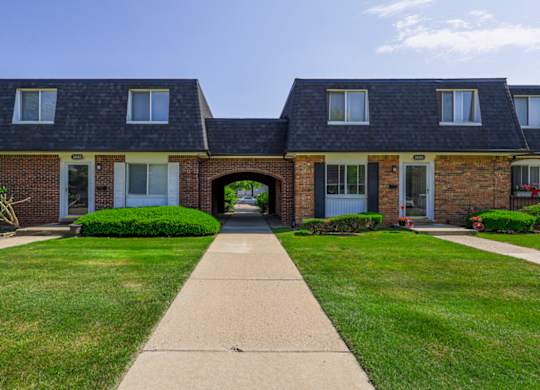A row of houses with a walkway in the middle.