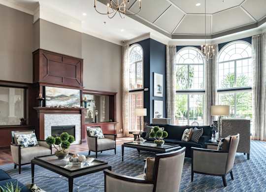 A living room with a fireplace and a chandelier.