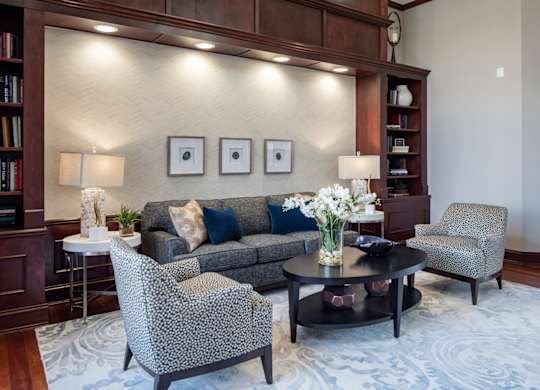 a living room with a couch and chairs and a table