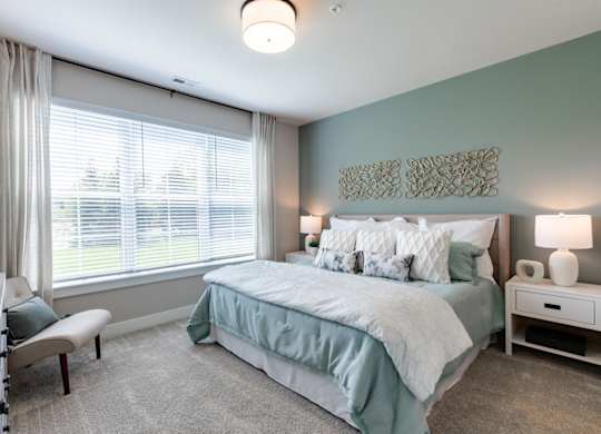 a bedroom with a bed and a large window
