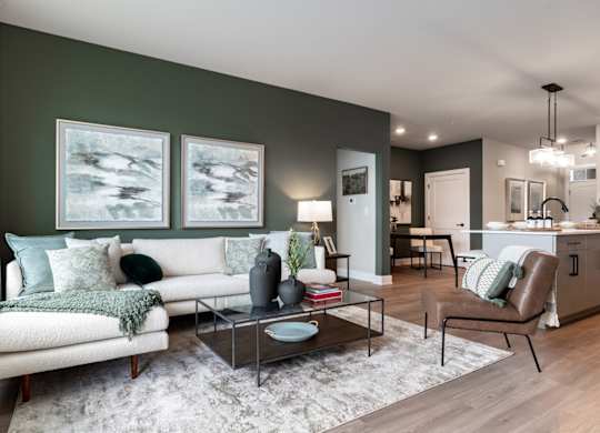 a living room with green walls and a white couch