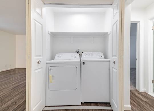 A small laundry room with a washer and dryer.
