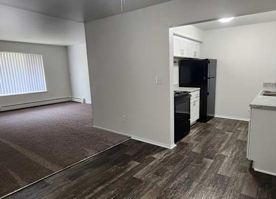 A kitchen area with a refrigerator, microwave, and oven.