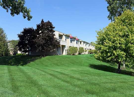 a large lawn in front of a row of houses