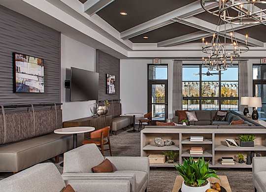 A modern living room with a large sectional sofa and a coffee table.