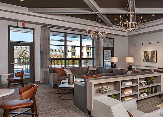 A large, open living room with a dining area and a kitchen in the background.