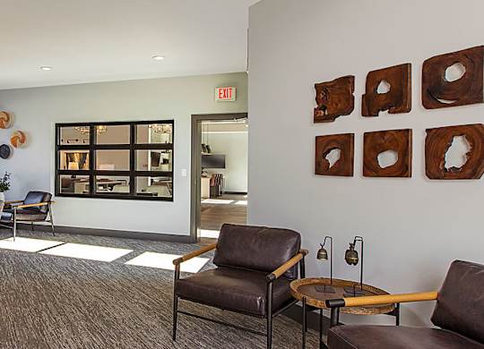 A room with brown chairs and a brown couch.