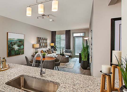 A modern kitchen with a large island and a sink.