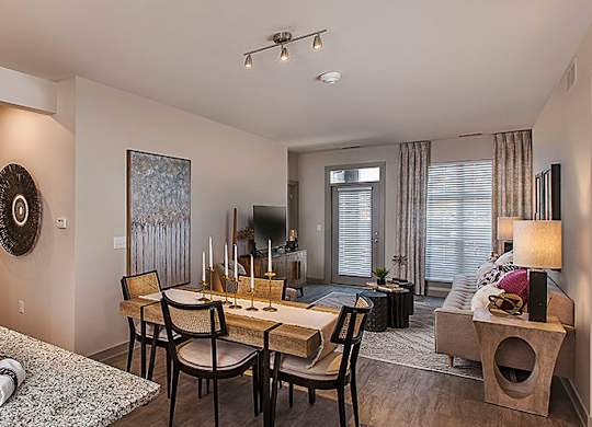 A modern kitchen with a breakfast bar and a dining area.
