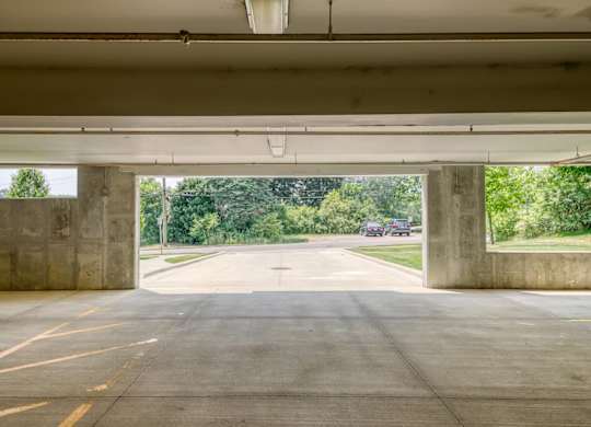 A concrete underpass with a road leading through it.