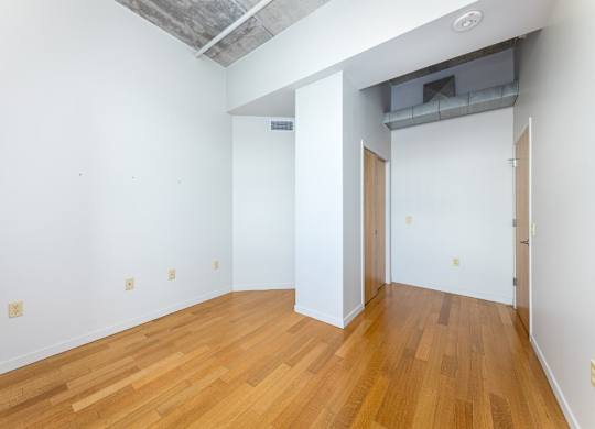 A room with wooden floors and white walls.