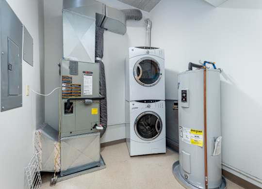 A room with a washing machine, dryer, and furnace.