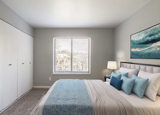 A bedroom with a large bed and a painting on the wall.