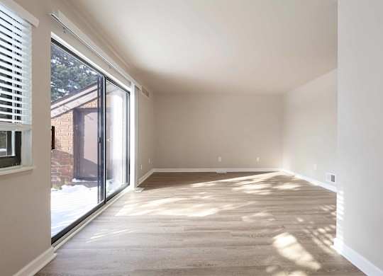 A sunny room with a sliding glass door.