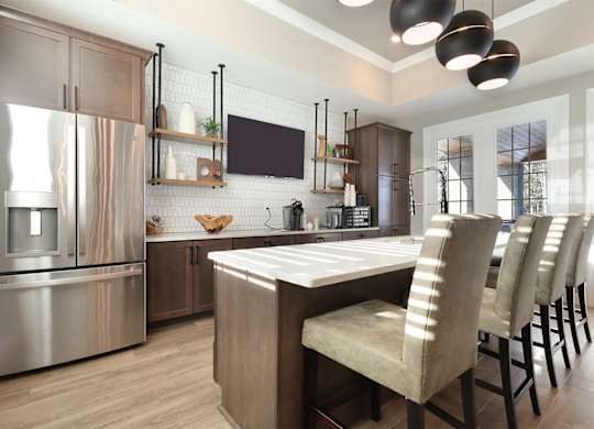 A modern kitchen with a large island and stainless steel appliances.