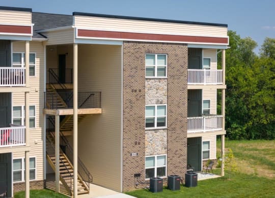 an exterior view of a building with stairs and balconies