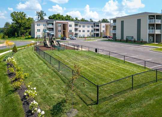 A view of apartment buildings with a playground in the foreground.