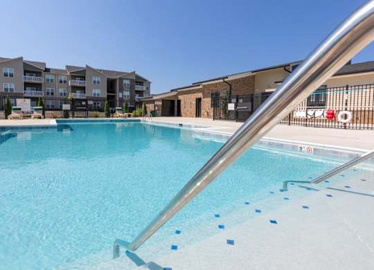 A swimming pool with a metal railing.