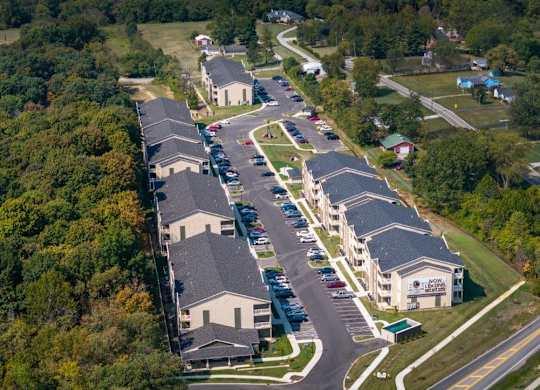An aerial view of a large building complex surrounded by trees.