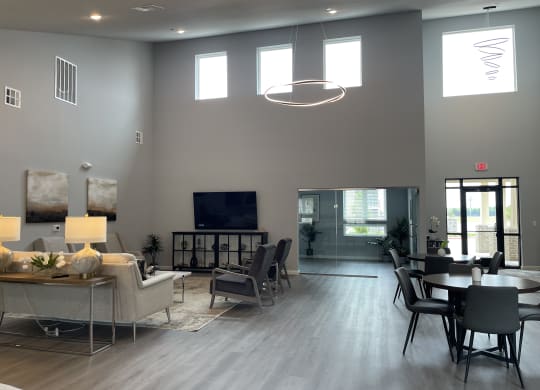 a large living room with a table and chairs and a television