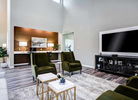 A living room with a large flat screen TV and a coffee table.