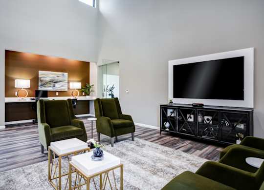 A living room with a large flat screen TV and a coffee table.