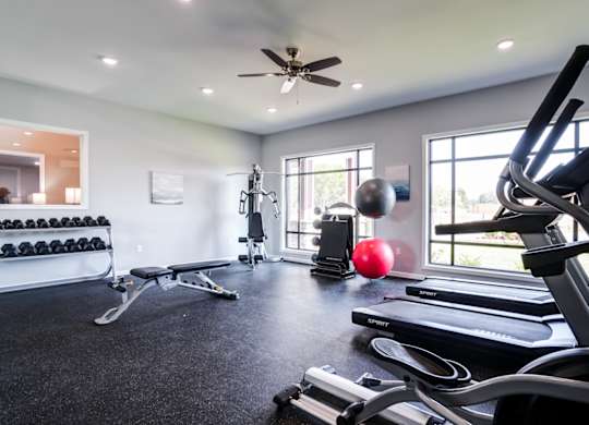 A spacious home gym with a variety of exercise equipment.