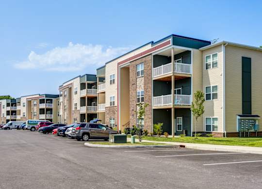 A parking lot in front of apartment buildings.