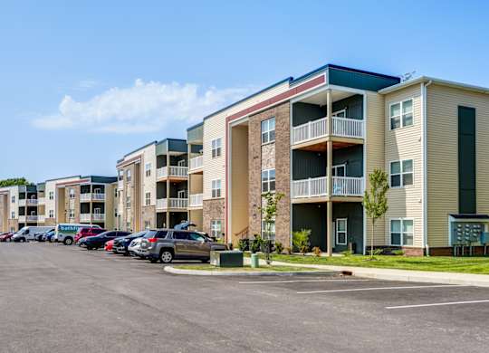 A parking lot in front of apartment buildings.