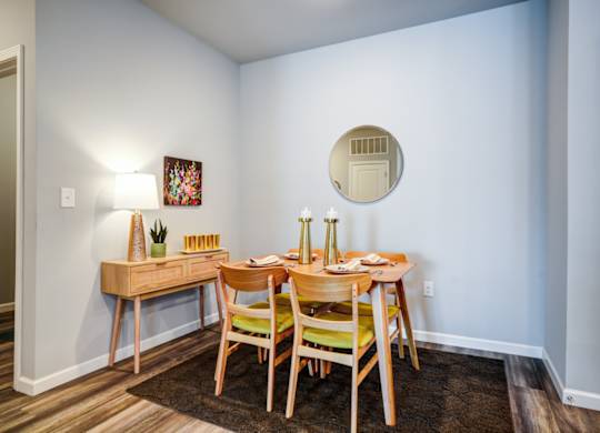 A dining room with a wooden table and chairs.