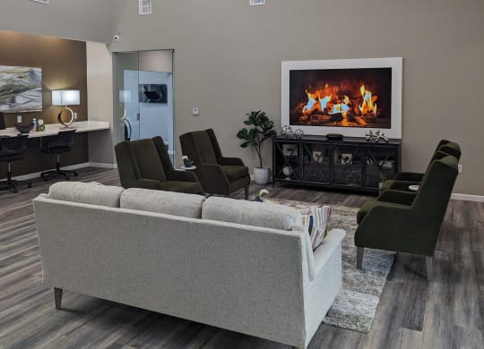 a living room with a fireplace and a couch and chairs
