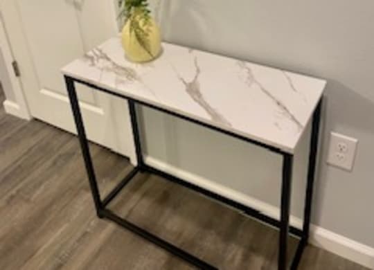 a small table with a vase on top of it