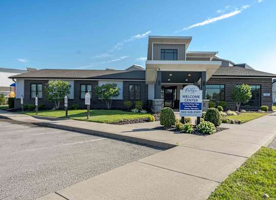 A building with a sign that says "Welcome Center" in front of it.