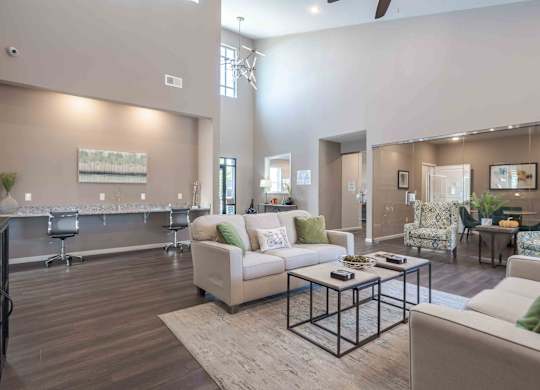 A spacious living room with a white sofa and a coffee table.