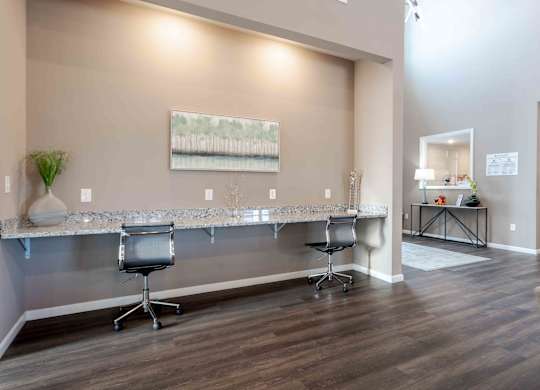 A room with a long table and chairs.
