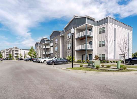 A parking lot in front of apartment buildings.