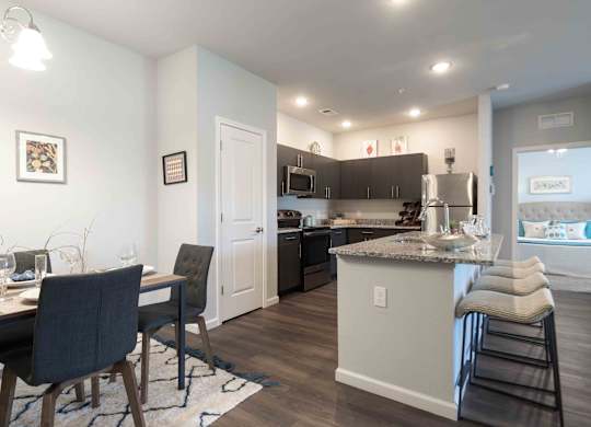 A kitchen with a bar area and a dining table.