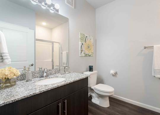 A bathroom with a white toilet and a white sink.