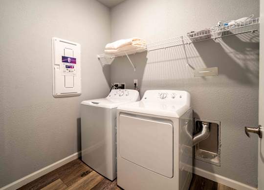 a washer and dryer in a laundry room with a wall mounted dryer