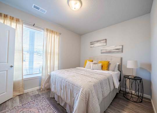 a bedroom with a bed and a window