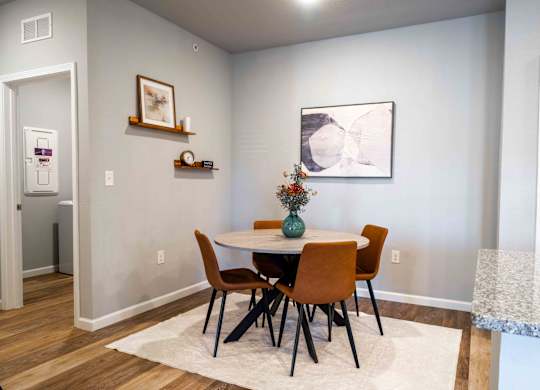 a dining room with a table and chairs