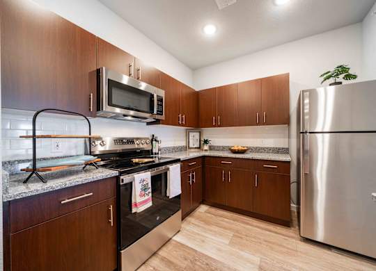 a kitchen with stainless steel appliances and wooden cabinets