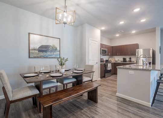 A modern kitchen with a dining table set for four.