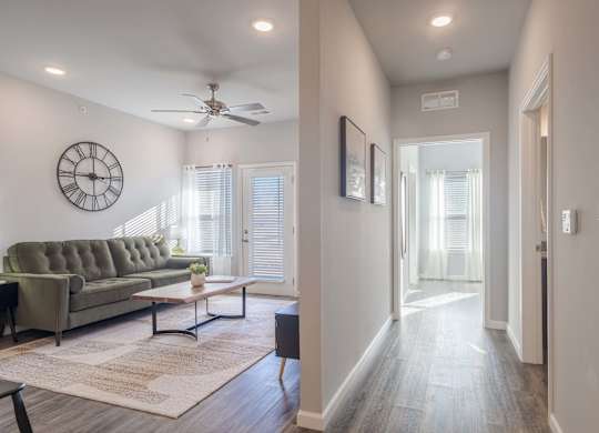A living room with a grey couch and a wooden coffee table.