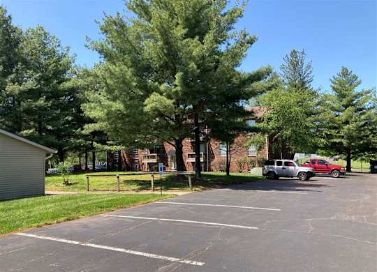 a parking lot with cars in front of a brick building